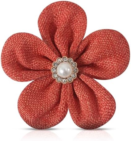 A 2.2 inch silk flower brooch pinned with a simulated pearl center and fitted with both a clasp and hair clip.