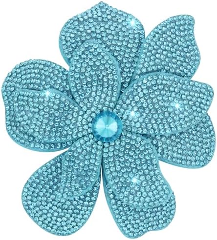 Blue polyester petals layered into a camellia, centered with clear created crystals on a dual clip and pin back.