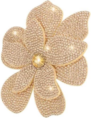 Layered polyester camellia petals in champagne with created crystal accents and a dual pin-and-clip mount.