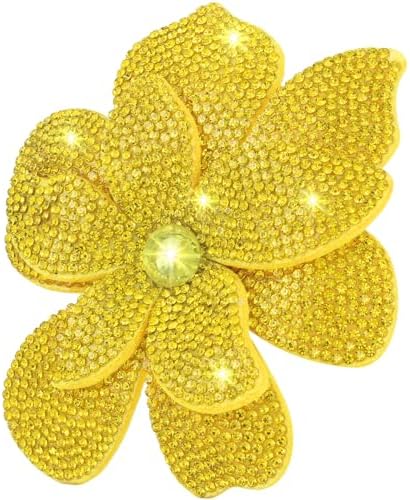 Layered yellow petals gather around a center of created crystal, built with both a pin stem and a hair clip.