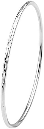 A carved sterling silver bangle stamped S925, shaped with a 6.7 cm inner diameter for stacking or wearing alone.