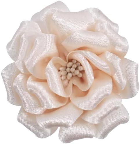 Layered fabric petals form this three inch camellia clip, fitted with a brooch pin for lapels and hats.