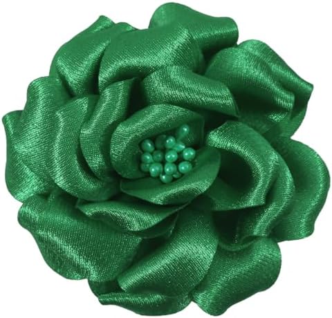 Layered green fabric petals form a three-inch camellia fitted with both a brooch pin and an alligator hair clip on the back.
