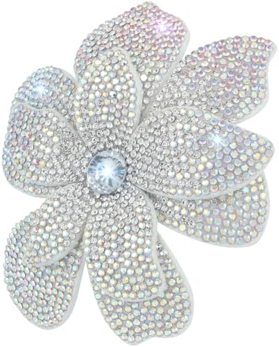 Layered white fabric petals and created crystals form a wide camellia brooch that doubles as a sturdy hair clip.