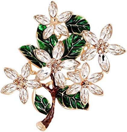 White glass flowers and green enameled leaves set on an alloy base, pinned with a classic rollover bar clasp.
