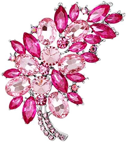 Rose red created glass crystals set along a feather frame with a sturdy pin back.