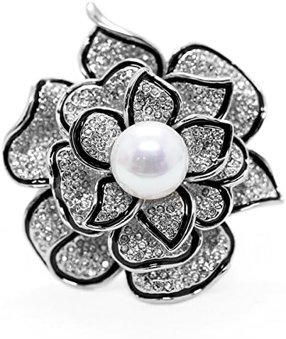 A floral brooch set with faceted glass created crystals and a simulated pearl on an alloy frame.